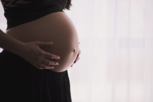 Un corps de personne enceinte, de profil
